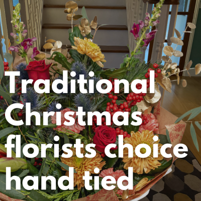 Traditional Christmas Hand Tied - Our expert, highly qualified florists will design a festive hand-tied filled with the finest quality seasonal flowers, in Red and Gold perfectly wrapped and delivered in water.